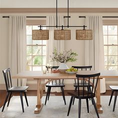 a dining room table with four chairs around it