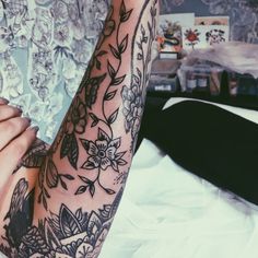 a woman's arm with tattoos on it