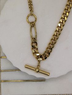 "Curb Gold This is a beautiful super trendy necklace for layering and for everyday wear. * DETAILS * ✤ Available in 14k Gold plated over brass ✤ Model is wearing size 16\" ✤ Toggle bar hang as a charm ✤ Available in Size 16\" 18\" and 20\" * PACKAGING * - Purchase is packaged in a Tommassini Jewelry box. - If you purchase more than one item, I will place it all into one box, unless requested otherwise in a note. * DON'T FORGET US * Instagram: https://instagram.com/tommassini_jewelry Facebook: ht Gold Toggle Necklace With Chain Link, Gold Toggle Necklace With Chunky Chain, Modern Chunky Chain Necklace Gift, Chunky Chain Choker Necklace As A Gift, Chunky Chain Choker Necklace For Gift, Minimalist Chunky Chain Necklace, Gold Chic Toggle Necklace For Everyday, Gold-tone Chunky Chain Necklace For Gift, Trendy Gold-plated Chunky Chain Necklace