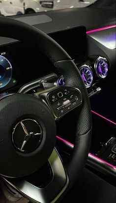 the interior of a car with steering wheel and gauges on display in a showroom