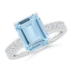 An emerald-cut aquamarine is secured in a prong setting on this solitaire engagement ring. Glistening diamonds adorn the shank and accentuate the cool blue gemstone. Crafted in 14k white gold, this solitaire ring will certainly leave her impressed. Emerald Cut Aquamarine Ring, Emerald Cut Solitaire Ring, Aquamarine Solitaire Ring, Aquamarine Cocktail Ring, Morganite Diamond, Aquamarine Engagement Ring, Aquamarine Jewelry, Ring With Diamond, Aquamarine Rings