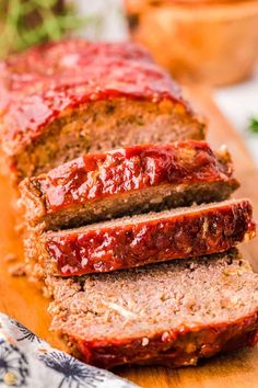 sliced meatloaf with ketchup on a cutting board