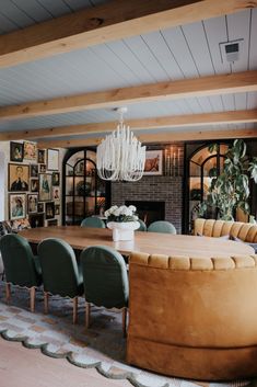 an oval dining table surrounded by green chairs