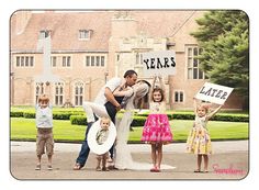 a family posing for a photo in front of a large building