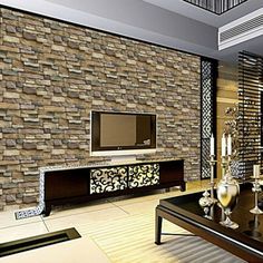 the living room is decorated with modern furniture and stone wall panels, along with a flat screen tv