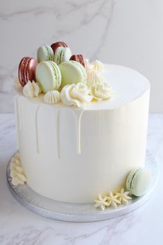 a white cake with macaroni and cheese frosting on top, sitting on a table