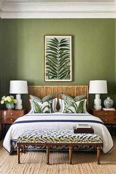 a bedroom with green walls and white bedding