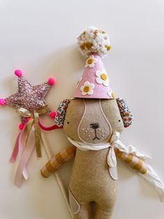 a stuffed animal wearing a party hat next to a star shaped decoration on the wall