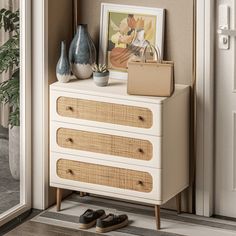 a white dresser with baskets and pictures on it