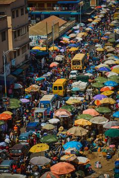 an aerial view of a crowded street with umbrellas