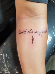 a woman with a tattoo on her arm that says wait he very end and an arrow