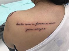 the back of a woman's shoulder with words written in cursive writing