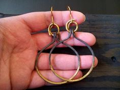 I created these fierce hoops out with brass wire that I hammered into elegant hoops. Then i added 20g ear wires and oxidized the brass from a dark charcoal to a shimmery bronze at the bottom. Ear hooks are made by me using 18g brass wire. Super light weight. All my jewelry coated with protective wax finish to prevent tarnish. Lenght from the bottom to the hook 2.5 inches / 6cm * These earrings are made to order handcrafted and shipped by me, so may take at least 5 business days before shipping * Everyday Handmade Brass Hoop Earrings, Everyday Hand Forged Bronze Earrings, Rustic Gold Brass Earrings, Everyday Hand Forged Brass Hoop Earrings, Minimalist Hand Forged Dangle Hoop Earrings, Minimalist Brass Earrings With Oxidized Finish, Small Brass Hoop Earrings, Hand Forged, Hand Forged Small Hoop Brass Earrings, Hand Forged Small Brass Hoop Earrings