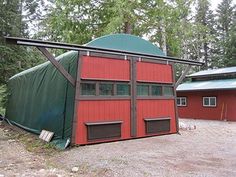 a red building with a green cover on it