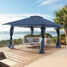 a blue gazebo sitting on top of a wooden deck