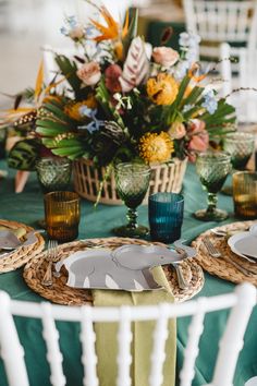 the table is set with plates and place settings