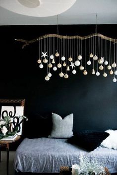 a black bedroom with ornaments hanging from the ceiling