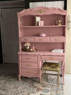 a pink desk and chair in a room