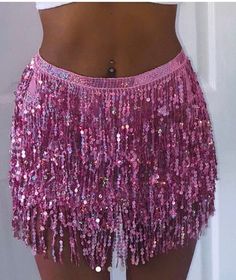 a close up of a person wearing a skirt with sequins on the bottom