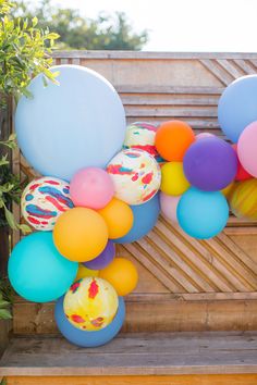 a bunch of balloons that are on a bench