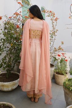 Muted clay anarkali with embroidered motifs and bead work. Comes with inner, straight pants and chiffon dupatta.
Component: 4
Pattern: Embroidery
Type Of Work: Thread and Beads
Neckline: Round
Sleeve Type: Full
Fabric: Anarkali: Chanderi and Kota; Inner: Cotton Silk; Pants: Cotton Silk and Dupatta: Chiffon
Color: Peach
Other Details: 
Lace trim on the hems
Buttoned cuffs
Dupatta with lace border
Occasion: Mehendi and Haldi - Aza Fashions Bollywood Peach Traditional Drape Sets, Designer Peach Cutdana Dupatta, Peach Dupatta With Cutdana In Traditional Drape, Navratri Traditional Drape Sets In Peach, Navratri Peach Sets In Traditional Drape, Peach Anarkali Set For Reception With Traditional Drape, Peach Traditional Sets With Dupatta, Traditional Drape Peach Sets For Navratri, Peach Traditional Drape Sets For Diwali