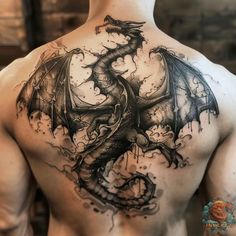 a man's back with a dragon tattoo on his upper and lower half body