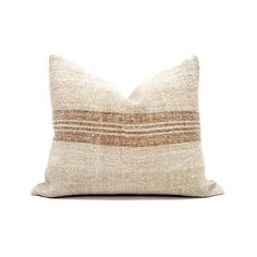 a beige and brown striped pillow on a white background