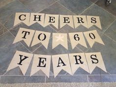 the letters cheers to 60 years are laid out on the floor with buntings