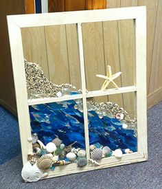 a window with shells and starfish in it