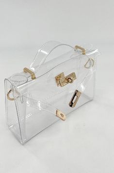 The Kelsey Clear Top Handle Bag is your chic ticket to breezing through NFL stadium security in style. With its transparent design, removable shoulder strap, and choice of silver or gold hardware, this bag ensures you’re game-day ready without sacrificing an ounce of glam. Item #PLS910-21 Size/Fit Measures W 8.5" x H 6" x D 2.5" inches. Trendy Crossbody Satchel With Clear Strap, Clear Shoulder Bag With Transparent Straps, Elegant Bag With Clear Strap For Daily Use, Elegant Bags With Clear Strap For Daily Use, Elegant Shoulder Bag With Clear Strap, Chic Clear Shoulder Bag With Clear Strap, Chic Clear Bag With Detachable Strap, Chic Clear Bags With Detachable Strap, Chic Shoulder Bag With Clear Strap For Travel