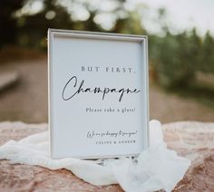 a photo frame sitting on top of a rock next to a white cloth draped over it