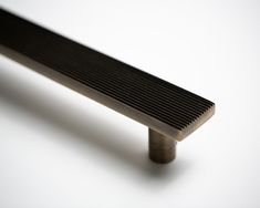 a metal bench sitting on top of a white floor next to a window sill