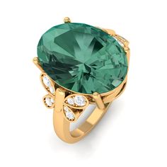 a large green ring with diamonds on the sides and an oval stone surrounded by smaller stones