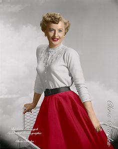 an old photo of a woman in a red skirt