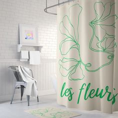 a shower curtain with the words les fleuris printed on it in green ink