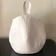 a white purse sitting on top of a black table