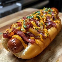 a hot dog covered in cheese and bacon