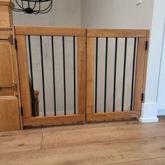 a dog is standing in front of a wooden door with bars on the top and bottom