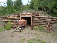 there is a small log cabin with logs in it