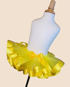 "Yellow Ribbon Trim Tutu This is a super cute tutu! You can purchase the tutu individually or add a top. Please put the name you would like on the bodysuit or shirt in the notes to seller at checkout. When washing please wash it inside out. I recommend hand washing the tutu. Please check out our shop for more items. Have any questions? Feel free to click that \"contact\" button. We will get back to you as soon as possible." Fitted Fun Style Tutu Dress For Spring, Spring Dance Tutu Dress With Stretch, Spring Tutu Dance Dress, Fitted Yellow Tutu Dress For Dress-up, Yellow Tutu Dress With Tulle Skirt For Spring, Spring Yellow Tutu Dress With Tulle Skirt, Fitted Yellow Tutu Dress With Tulle Skirt, Fitted Yellow Tutu Dress For Party, Yellow Fitted Tutu Dress For Party