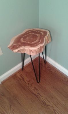 a wooden table sitting on top of a hard wood floor next to a blue wall