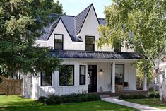 a white house with black roof and windows