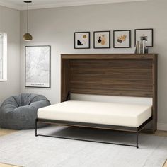 a bed with a wooden headboard and foot board next to a gray bean bag chair