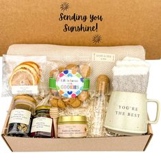 an open box containing cookies, jams and other items for someone's special occasion