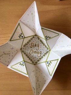 an origami star with the words stay strong written on it