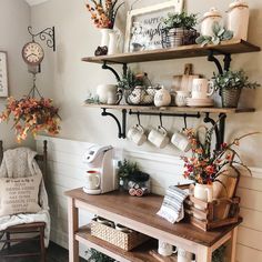 a coffee bar with shelves filled with mugs and other items on top of it