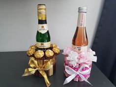 two bottles of champagne and some chocolates on a table