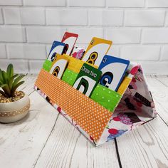 an image of children's books in the shape of a book holder on a white wooden table