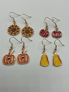 Four pack of fall themed earrings, makes sharing or gifting easy. Gold color back side, enamel charms on gold fish hook style earrings. Earring Pack, Pumpkin Autumn, Gold Fish, Fall Earrings, Enamel Charms, Style Earrings, Autumn Theme, Goldfish, Fish Hook