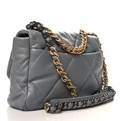 This is an authentic CHANEL Lambskin Quilted Large Chanel 19 Flap in Grey. This pillowy soft shoulder bag is crafted of oversized quilted lambskin leather in light grey. The refined bag features a chain detail CC turn-lock on the flap, a magnetic snap pocket at the rear, and a leather threaded aged gold, ruthenium, and dark silver chain-link shoulder strap with a leather shoulder pad. The front flap opens to a matching gray fabric interior with a zipper pocket. Chanel 19, Leather Thread, Gray Fabric, Grey Fabric, Lambskin Leather, Shoulder Pads, Chain Link, Zipper Pocket, Silver Chain